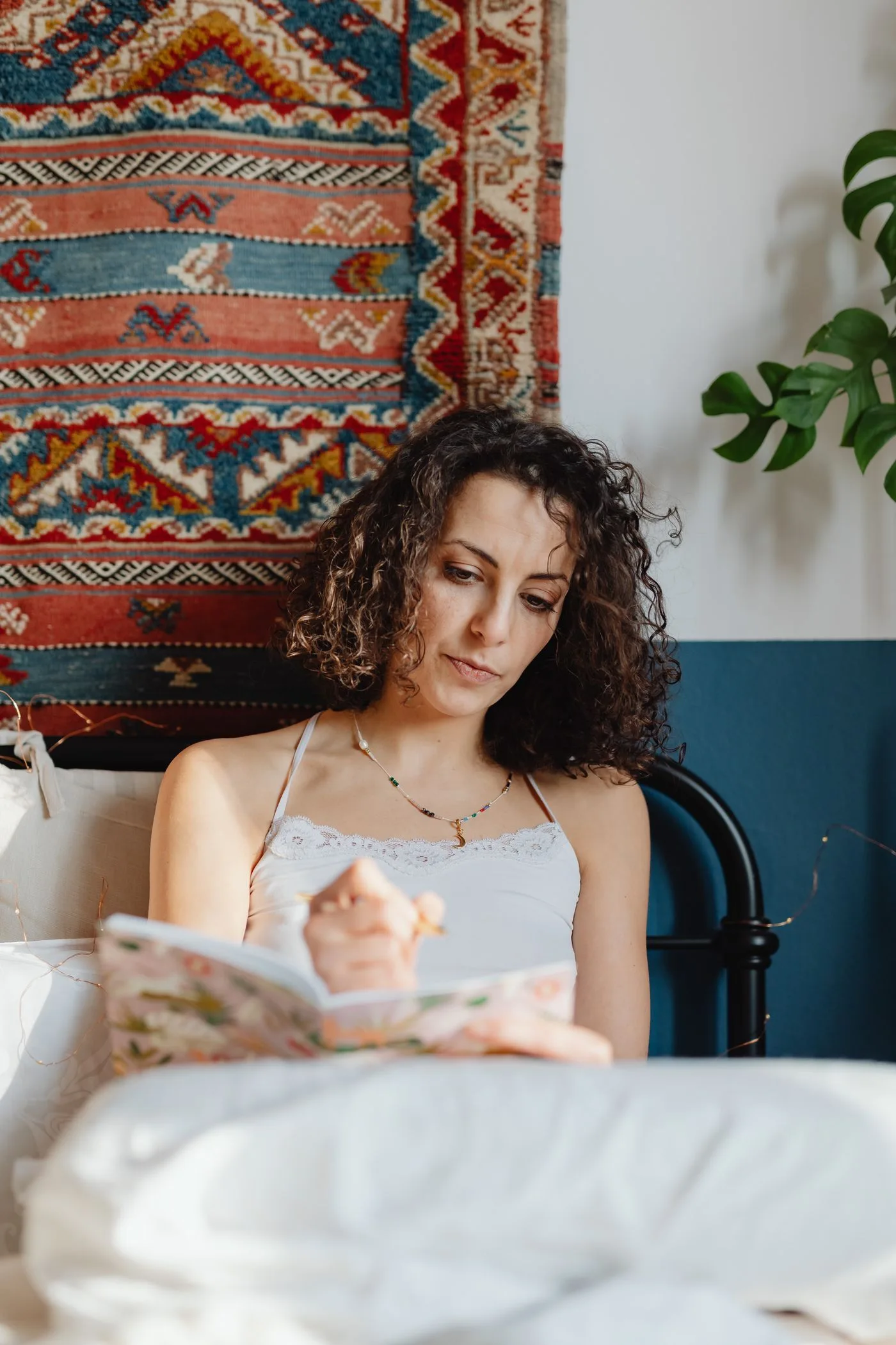 A woman writing in a notebook during a quiet moment at home
