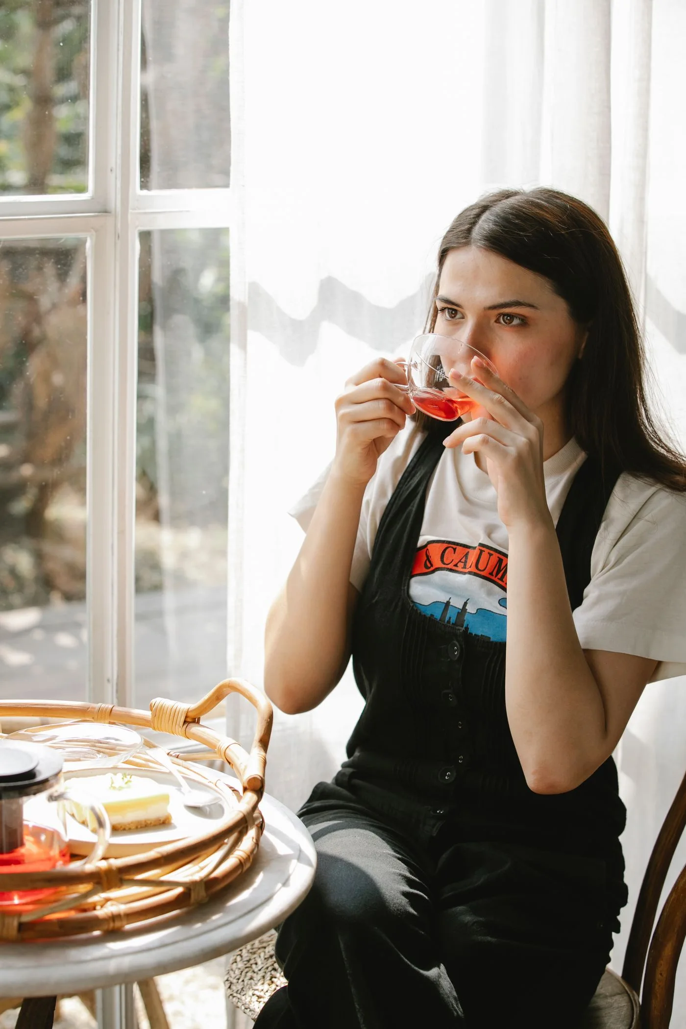 A woman taking a morning tea break at a sunlit table